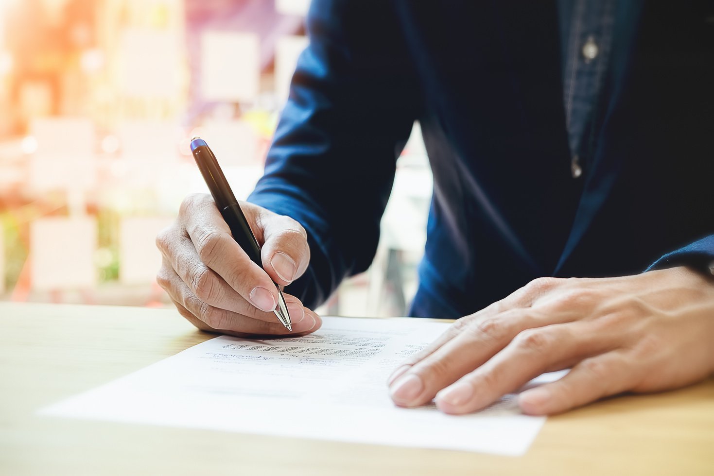 Close-up of Businessperson Signing Contract